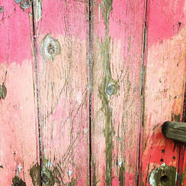 distressed pink wooden door